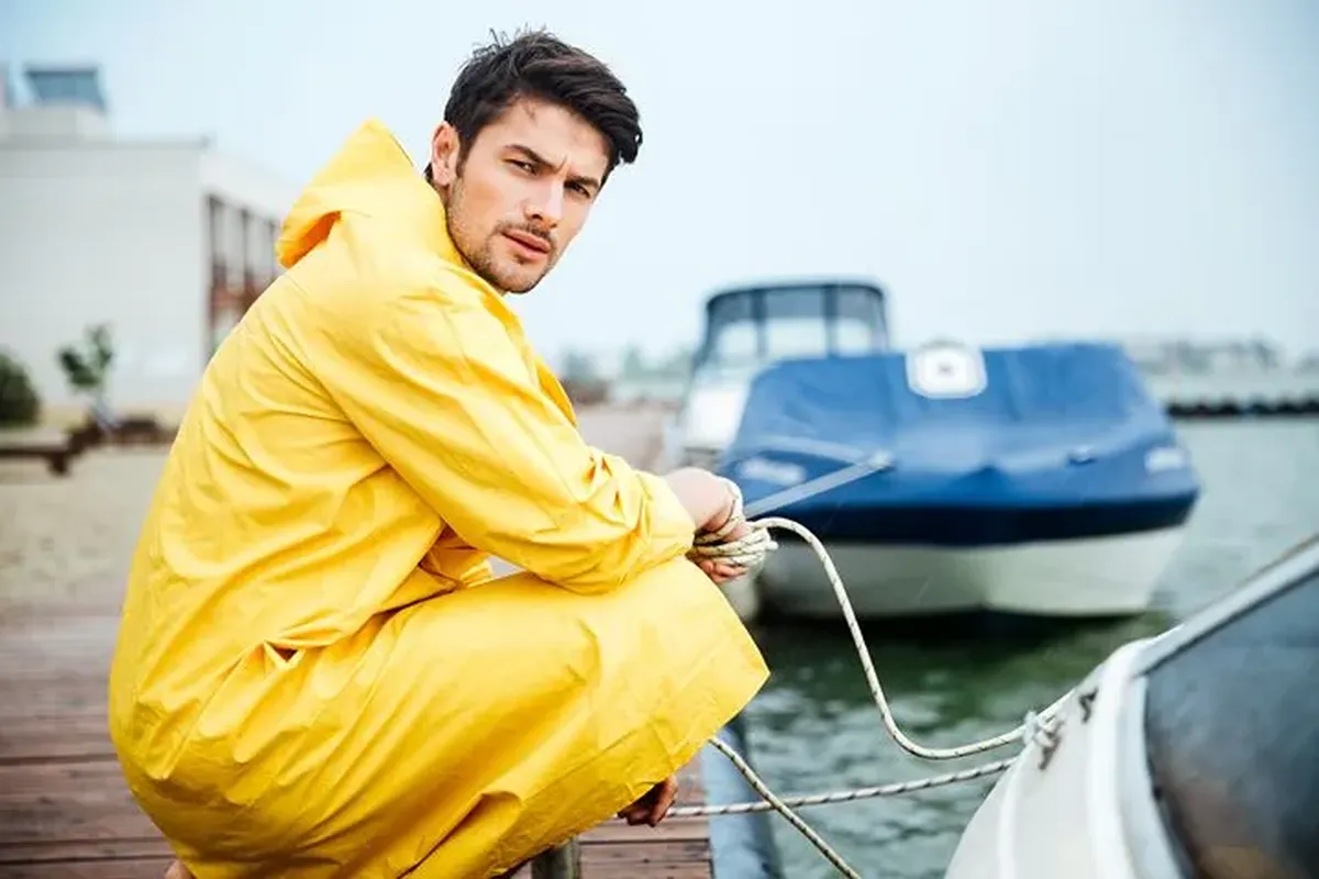 Worker in yellow waterproof coveralls at a pier — waterproof clothing for Irish outdoor conditions